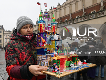 KRAKOW, POLAND - DECEMBER 05:
A contestant presents their handcrafted Nativity Scene at Krakow's Main Square during the 82nd Nativity Scene...