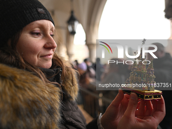 KRAKOW, POLAND - DECEMBER 05:
A contestant presents their handcrafted Nativity Scene at Krakow's Main Square during the 82nd Nativity Scene...