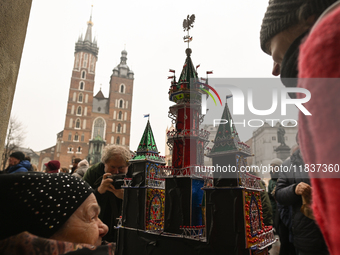 KRAKOW, POLAND - DECEMBER 05:
A contestant presents their handcrafted Nativity Scene at Krakow's Main Square during the 82nd Nativity Scene...