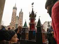 KRAKOW, POLAND - DECEMBER 05:
A contestant presents their handcrafted Nativity Scene at Krakow's Main Square during the 82nd Nativity Scene...