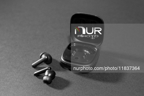 Black wireless headphones sit on a table in Athens, Greece, on December 5, 2024. (Photo Illustration  by Nikolas Kokovlis/NurPhoto)