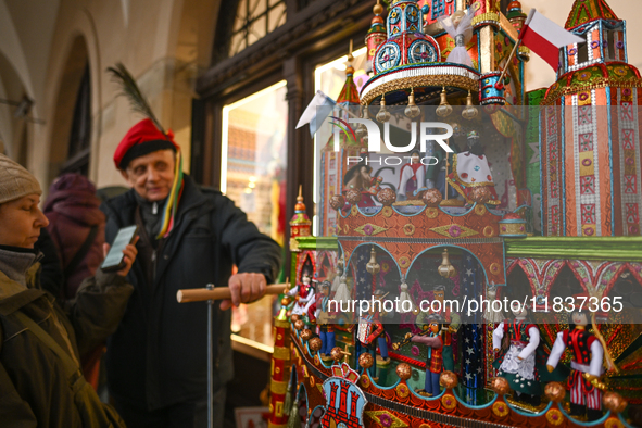 KRAKOW, POLAND - DECEMBER 05:
A contestant presents their handcrafted Nativity Scene at Krakow's Main Square during the 82nd Nativity Scene...