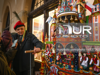 KRAKOW, POLAND - DECEMBER 05:
A contestant presents their handcrafted Nativity Scene at Krakow's Main Square during the 82nd Nativity Scene...