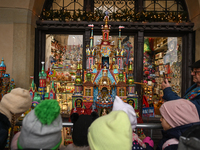 KRAKOW, POLAND - DECEMBER 05:
Visitors, tourists, and locals gather in Krakow's Main Square, capturing photos of the detailed handcrafted Na...