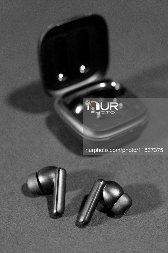 Black wireless headphones sit on a table in Athens, Greece, on December 5, 2024. (Photo Illustration  by Nikolas Kokovlis/NurPhoto)