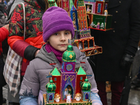 KRAKOW, POLAND - DECEMBER 05:
A family of contestants showcases their handcrafted Nativity Scene in Krakow's Main Square during the 82nd Nat...