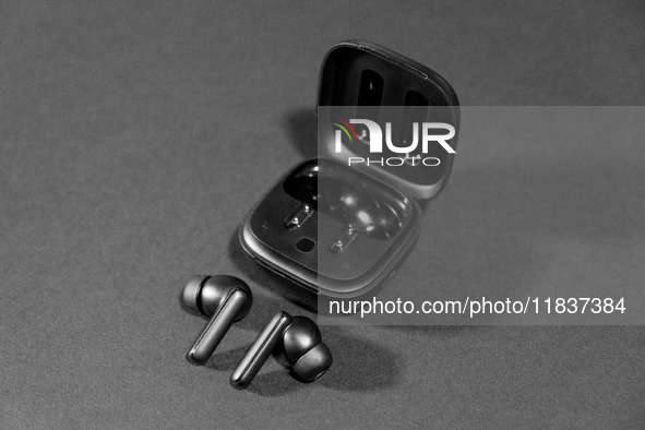 Black wireless headphones sit on a table in Athens, Greece, on December 5, 2024. (Photo Illustration  by Nikolas Kokovlis/NurPhoto)