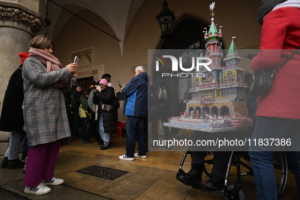 KRAKOW, POLAND - DECEMBER 05:
A contestant presents their handcrafted Nativity Scene at Krakow's Main Square during the 82nd Nativity Scene...