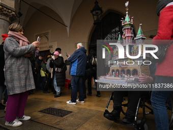 KRAKOW, POLAND - DECEMBER 05:
A contestant presents their handcrafted Nativity Scene at Krakow's Main Square during the 82nd Nativity Scene...