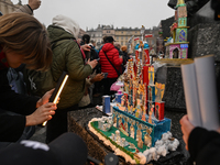 KRAKOW, POLAND - DECEMBER 05:
Visitors, tourists, and locals gather in Krakow's Main Square, capturing photos of the detailed handcrafted Na...