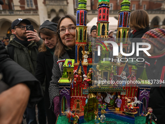 KRAKOW, POLAND - DECEMBER 05:
A contestant presents their handcrafted Nativity Scene at Krakow's Main Square during the 82nd Nativity Scene...