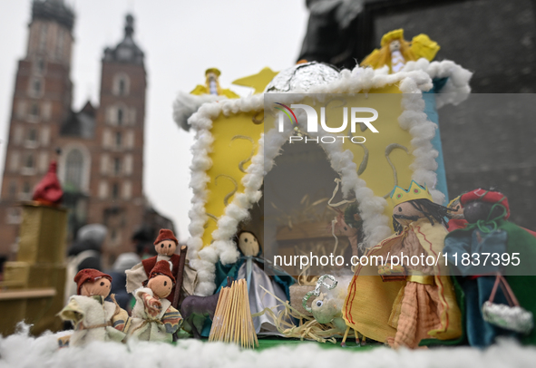 KRAKOW, POLAND - DECEMBER 05:
A contestant presents their handcrafted Nativity Scene at Krakow's Main Square during the 82nd Nativity Scene...