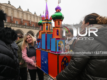 KRAKOW, POLAND - DECEMBER 05:
Contestants arrive with their handcrafted Nativity Scene at Krakow's Main Square during the 82nd Nativity Scen...