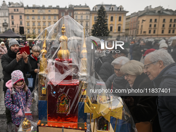 KRAKOW, POLAND - DECEMBER 05:
A contestant presents their handcrafted Nativity Scene at Krakow's Main Square during the 82nd Nativity Scene...