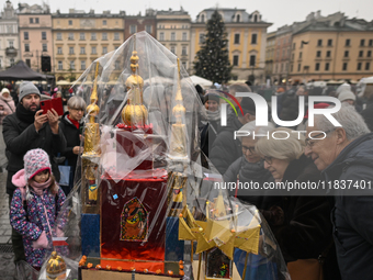 KRAKOW, POLAND - DECEMBER 05:
A contestant presents their handcrafted Nativity Scene at Krakow's Main Square during the 82nd Nativity Scene...