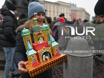 KRAKOW, POLAND - DECEMBER 05:
A contestant presents their handcrafted Nativity Scene at Krakow's Main Square during the 82nd Nativity Scene...