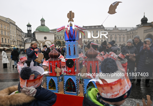 KRAKOW, POLAND - DECEMBER 05:
A group of young contestants from kindergarten number 95 presents their handcrafted Nativity Scene at Krakow's...