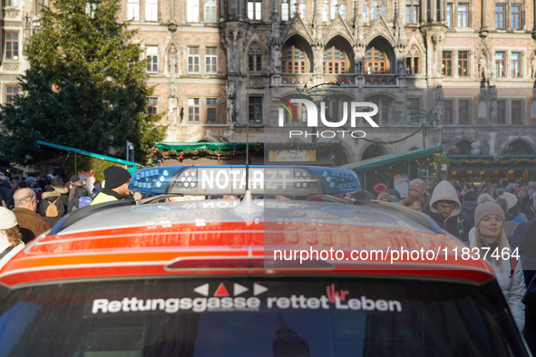 An emergency doctor vehicle is at the Christmas market on Marienplatz in Munich. 