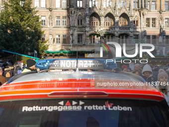 An emergency doctor vehicle is at the Christmas market on Marienplatz in Munich. (