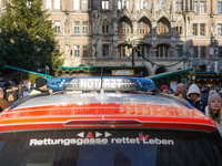 An emergency doctor vehicle is at the Christmas market on Marienplatz in Munich. (