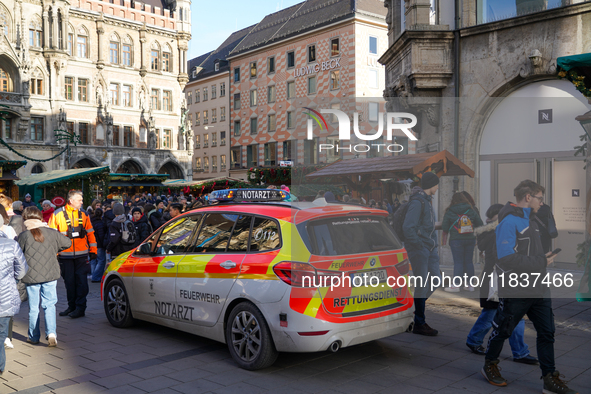 An emergency doctor vehicle is at the Christmas market on Marienplatz in Munich. 