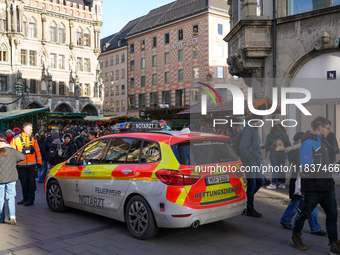 An emergency doctor vehicle is at the Christmas market on Marienplatz in Munich. (