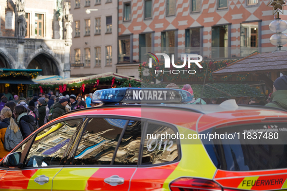 An emergency doctor vehicle is at the Christmas market on Marienplatz in Munich. 