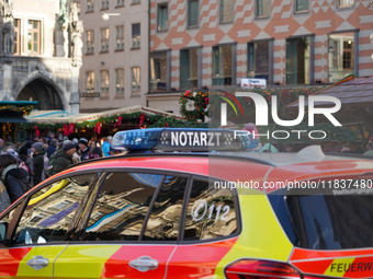 An emergency doctor vehicle is at the Christmas market on Marienplatz in Munich. (