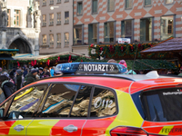 An emergency doctor vehicle is at the Christmas market on Marienplatz in Munich. (