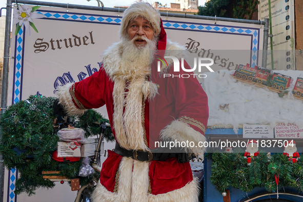 Santa Claus rides a festively decorated bicycle at the Christmas market in Munich, Germany, on December 5, 2024. 