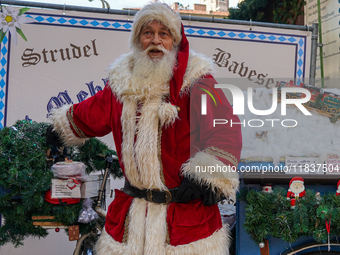 Santa Claus rides a festively decorated bicycle at the Christmas market in Munich, Germany, on December 5, 2024. (