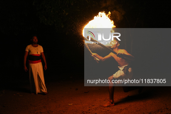 Angampora students perform their skills using fire and swords in Eheliyagoda, Sri Lanka, on December 5, 2024. Angampora is a 3,000-year-old...