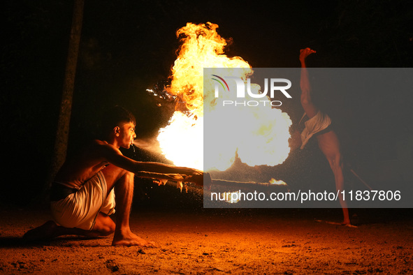 Angampora students perform their skills using fire and swords in Eheliyagoda, Sri Lanka, on December 5, 2024. Angampora is a 3,000-year-old...