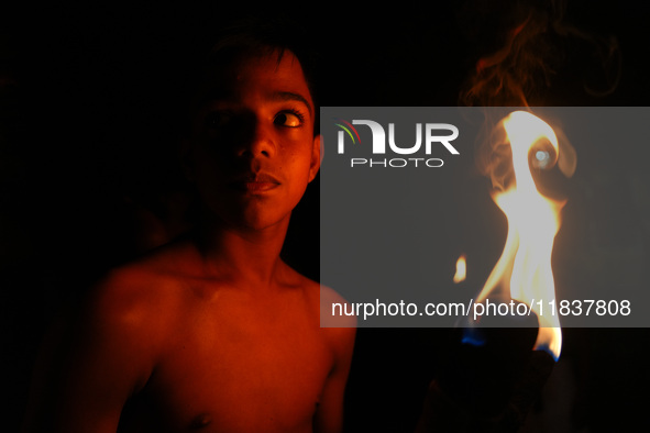 An Angampora student holds a fire torch in Eheliyagoda, Sri Lanka, on December 5, 2024. Angampora is a 3,000-year-old martial art from Sri L...