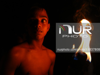 An Angampora student holds a fire torch in Eheliyagoda, Sri Lanka, on December 5, 2024. Angampora is a 3,000-year-old martial art from Sri L...