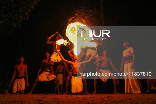 Angampora students perform their skills using fire in Eheliyagoda, Sri Lanka, on December 5, 2024. Angampora is a 3,000-year-old martial art...