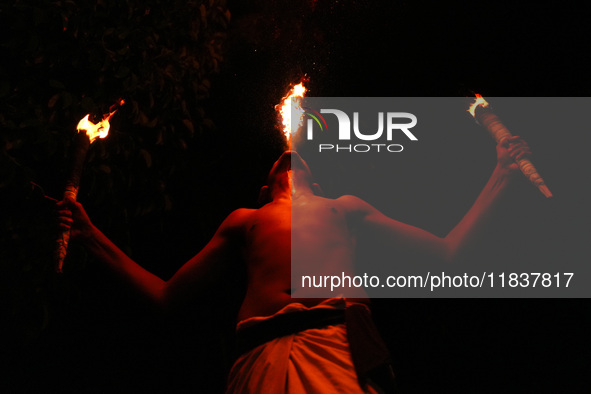 Angampora students perform their skills using fire in Eheliyagoda, Sri Lanka, on December 5, 2024. Angampora is a 3,000-year-old martial art...