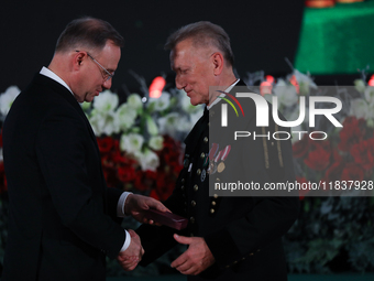 In Wieliczka, Poland, on December 2, 2024, the President of Poland, Andrzej Duda, presents decorations during the celebration of Saint Barba...