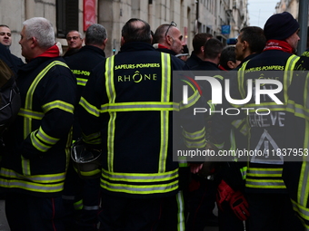 Several hundred firefighters demonstrate during the Lyon Festival of Lights in Lyon, France, on December 5, 2024. They demand the creation o...