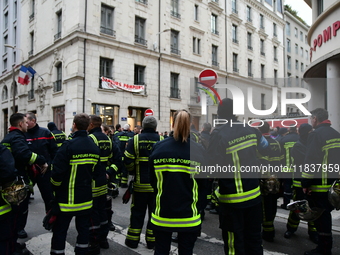 Several hundred firefighters demonstrate during the Lyon Festival of Lights in Lyon, France, on December 5, 2024. They demand the creation o...