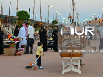 People visit the 14th Katara Traditional Dhow Festival in Katara Cultural Village in Doha, Qatar, on December 5, 2024. The festival celebrat...