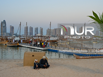 Traditional wooden dhows are on display during the 14th Katara Traditional Dhow Festival in Katara Cultural Village in Doha, Qatar, on Decem...