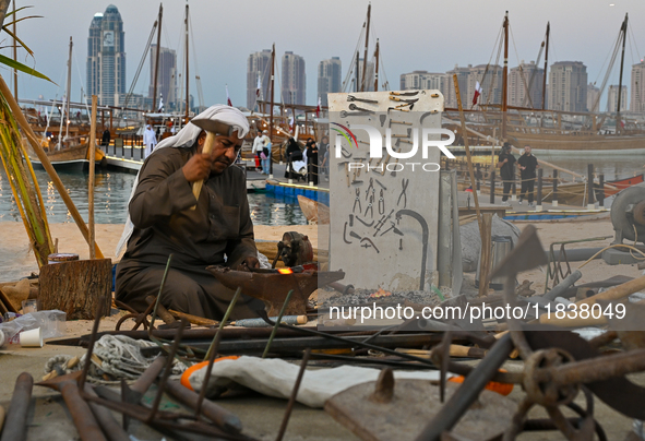 A man makes an anchor during the 14th Katara Traditional Dhow Festival in Katara Cultural Village in Doha, Qatar, on December 5, 2024. The f...