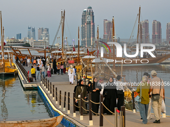 People visit the 14th Katara Traditional Dhow Festival in Katara Cultural Village in Doha, Qatar, on December 5, 2024. The festival celebrat...