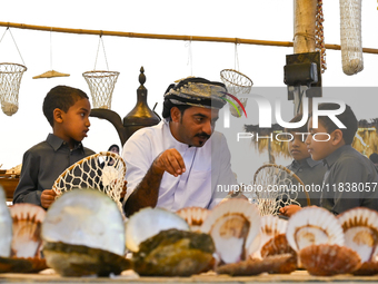 A man makes an oyster basket during the 14th Katara Traditional Dhow Festival in Katara Cultural Village in Doha, Qatar, on December 5, 2024...