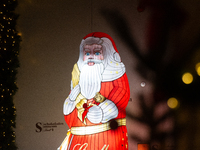 A general view shows an illuminated Lindt Santa Claus figure in front of the Lindt Chocolate Museum at the Cologne Harbor Christmas Market i...