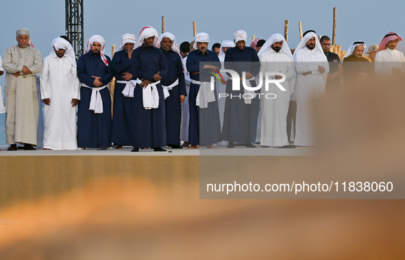 Locals pray during the 14th Katara Traditional Dhow Festival in Katara Cultural Village in Doha, Qatar, on December 5, 2024. The festival ce...