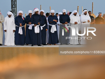 Locals pray during the 14th Katara Traditional Dhow Festival in Katara Cultural Village in Doha, Qatar, on December 5, 2024. The festival ce...