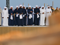 Locals pray during the 14th Katara Traditional Dhow Festival in Katara Cultural Village in Doha, Qatar, on December 5, 2024. The festival ce...