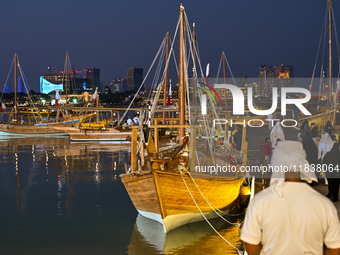 Traditional wooden dhows are on display during the 14th Katara Traditional Dhow Festival in Katara Cultural Village in Doha, Qatar, on Decem...